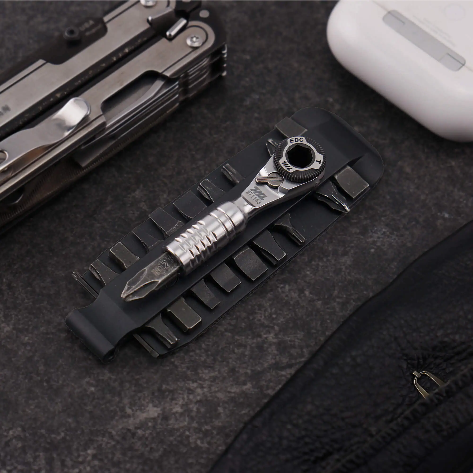 711L Mini Ratchet Wrench TG and bits arranged in a bit tray alongside other multitool components